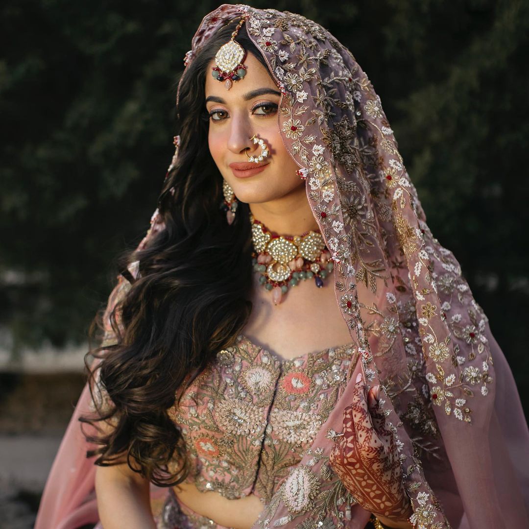 The Bride Donned A Rose Pink Lehenga With Open Hairstyle For Her Day  Wedding
