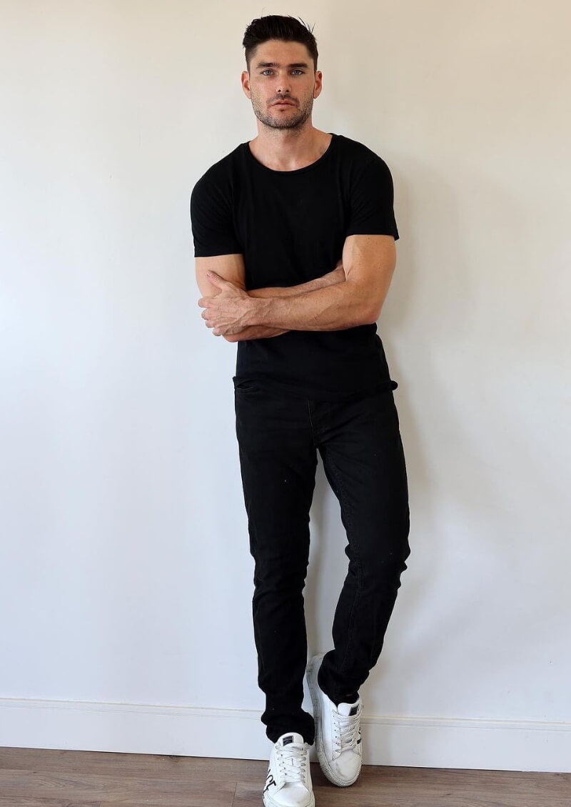 Charlie Matthews In a Black T-shirt With Jeans