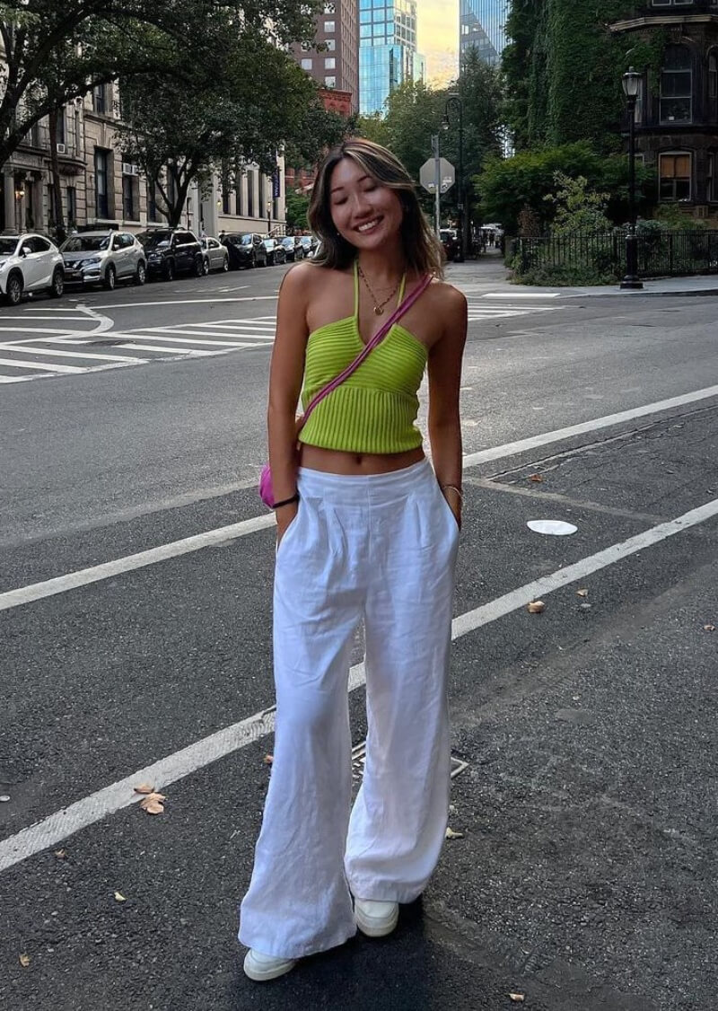 Yuyan In a Neon Woven Top With White Pants