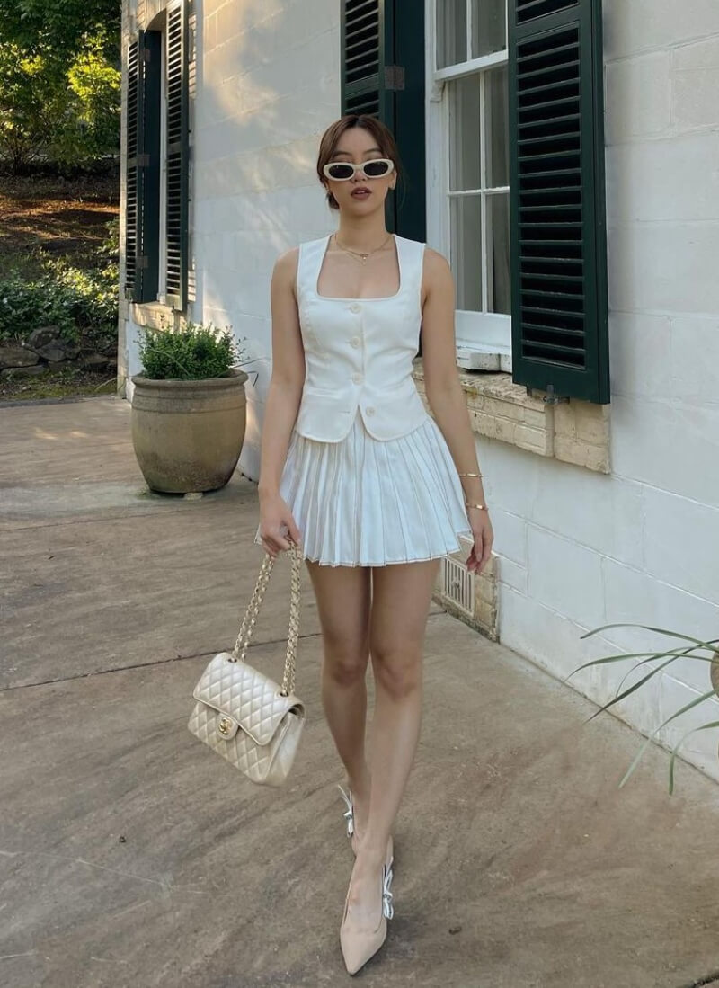 Ashleigh Huynh In White Waist Coat With Pleated Mini Skirt